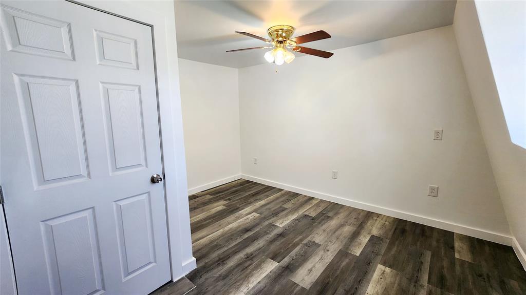 401 East Pierce Street Winters, TX 79567 - Photo 11 of 25 wooden floor in an empty room