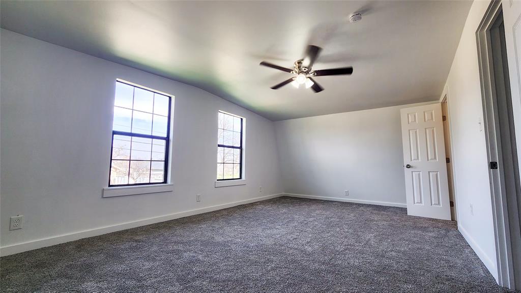 401 East Pierce Street Winters, TX 79567 - Photo 12 of 25 a view of empty room with windows