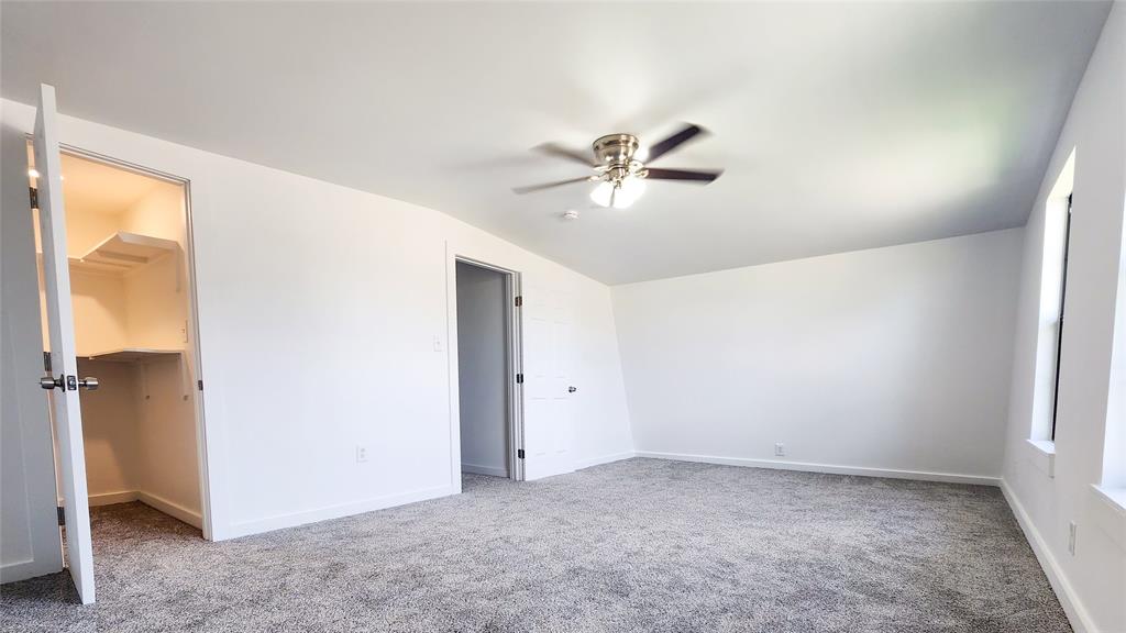 401 East Pierce Street Winters, TX 79567 - Photo 13 of 25 an empty room with a ceiling fan and a window