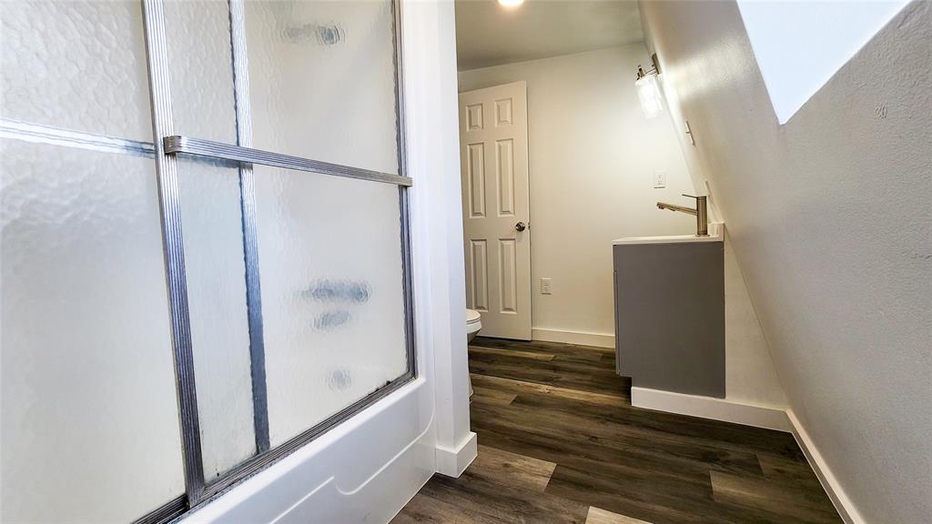 401 East Pierce Street Winters, TX 79567 - Photo 15 of 25 a view of a hallway with wooden floor and staircase