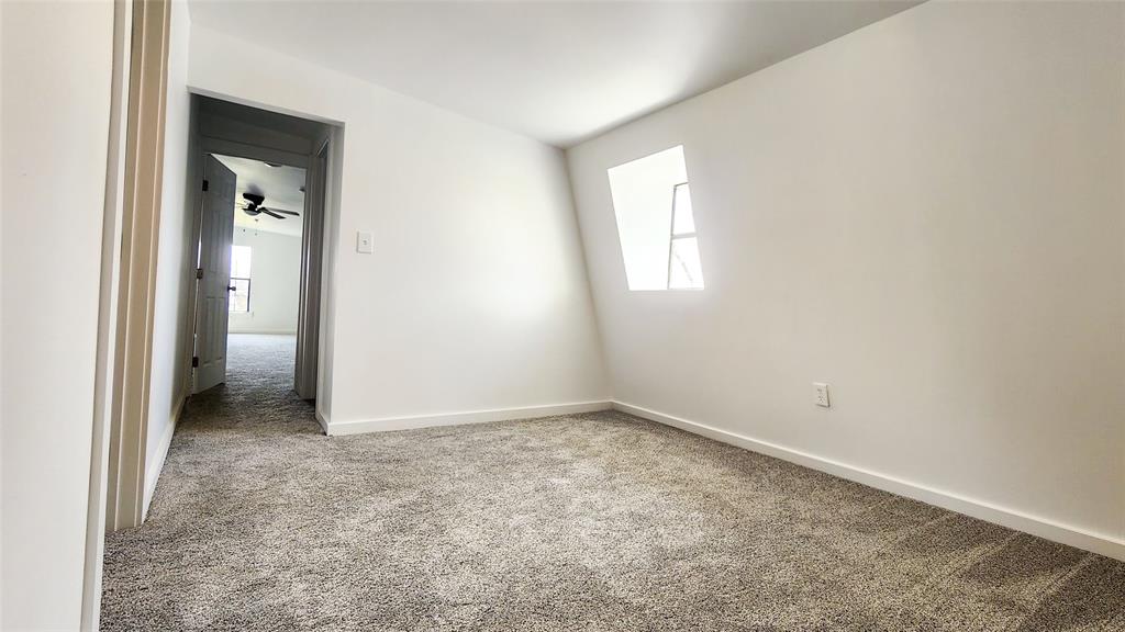 401 East Pierce Street Winters, TX 79567 - Photo 16 of 25 an empty room that has a window in it