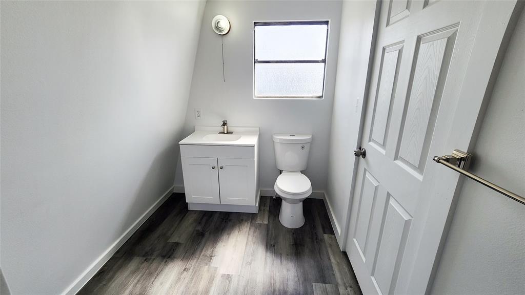 401 East Pierce Street Winters, TX 79567 - Photo 20 of 25 a view of bathroom with a toilet sink and window