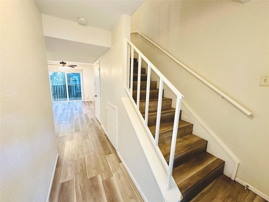 a view of entryway with wooden floor and stairs