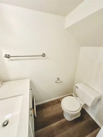 a white toilet sitting next to a bathroom sink