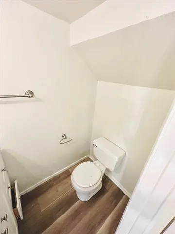 a white toilet sitting next to a bathroom sink