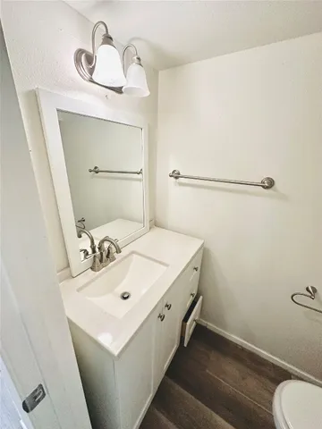a bathroom with a sink a toilet and mirror