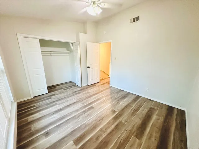 a view of a room with wooden floor and entryway