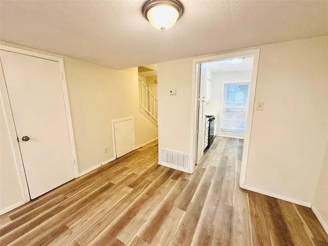 a view of a room with wooden floor and bathroom