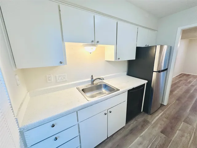 a kitchen with a sink and a refrigerator