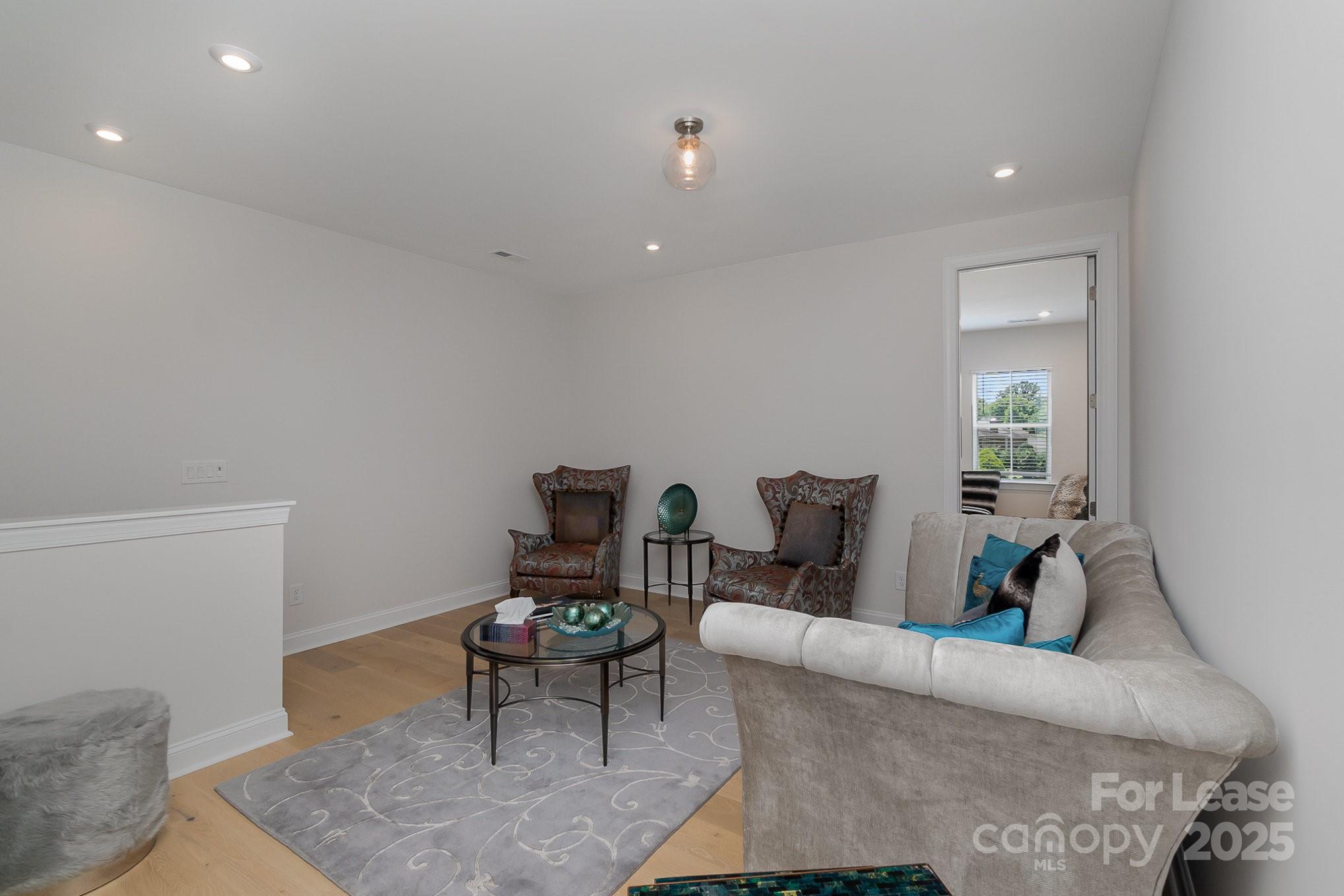 3224 Everly Enclave Way Charlotte, NC 28210 - Photo 11 of 24 a living room with furniture and a potted plant
