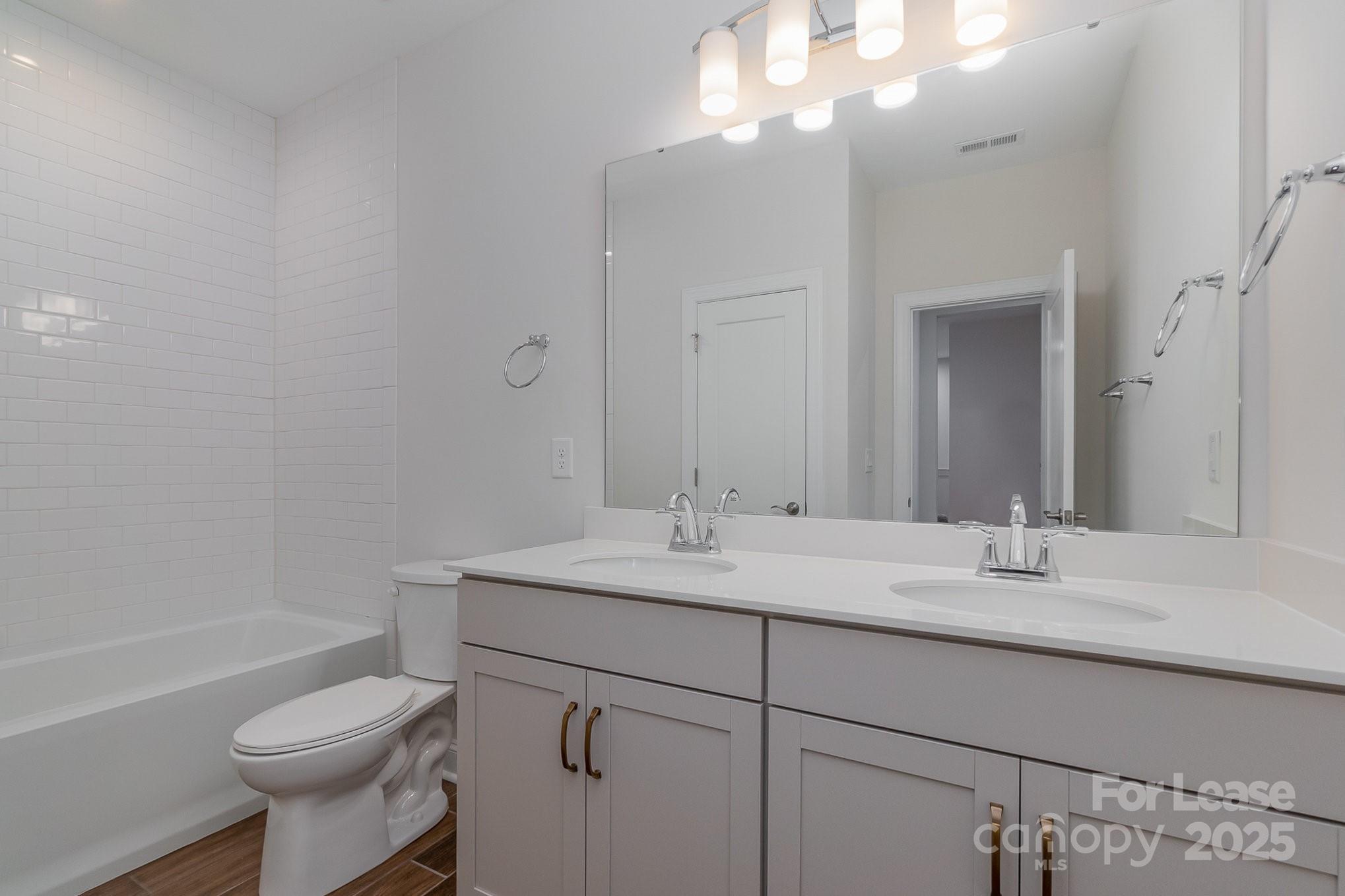 3224 Everly Enclave Way Charlotte, NC 28210 - Photo 12 of 24 a bathroom with a sink toilet vanity and tub