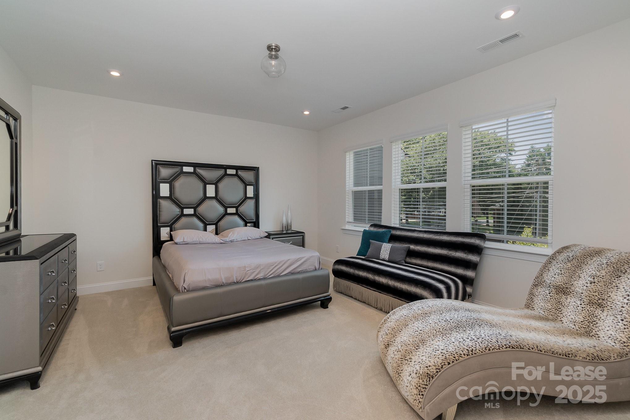 3224 Everly Enclave Way Charlotte, NC 28210 - Photo 14 of 24 a bedroom with a bed and wooden floor