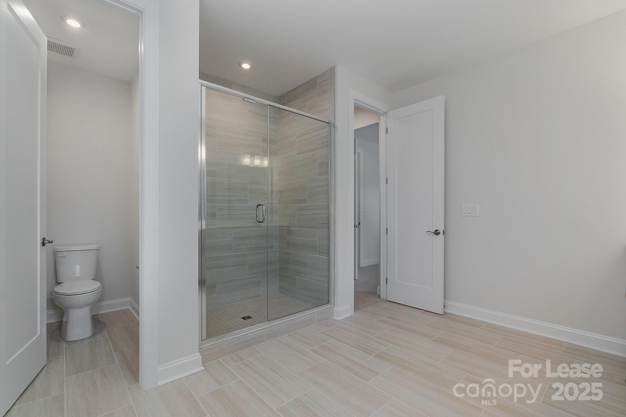 3224 Everly Enclave Way Charlotte, NC 28210 - Photo 16 of 24 a bathroom with a shower and a toilet