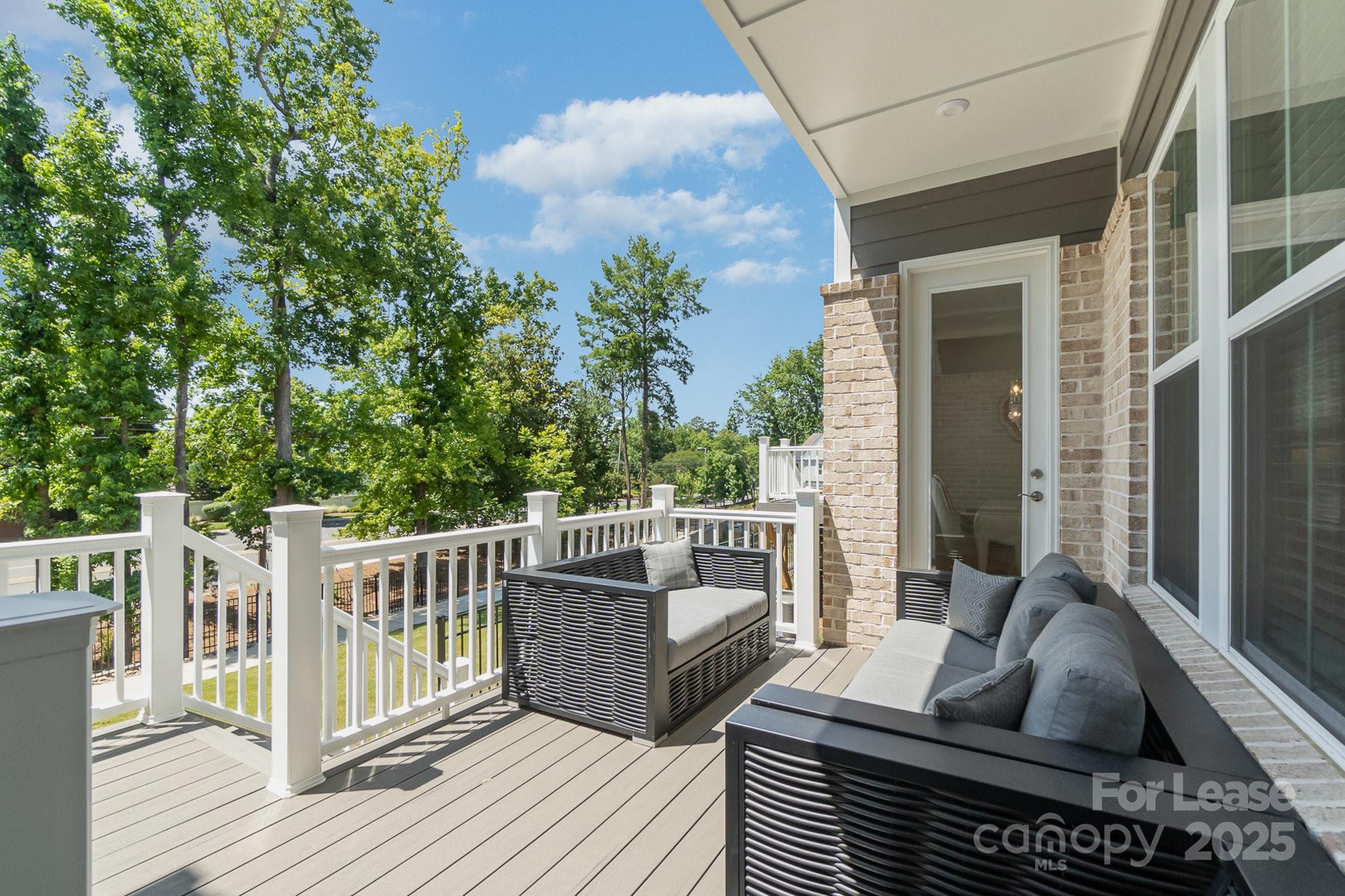 3224 Everly Enclave Way Charlotte, NC 28210 - Photo 24 of 24 a balcony with furniture and wooden floor