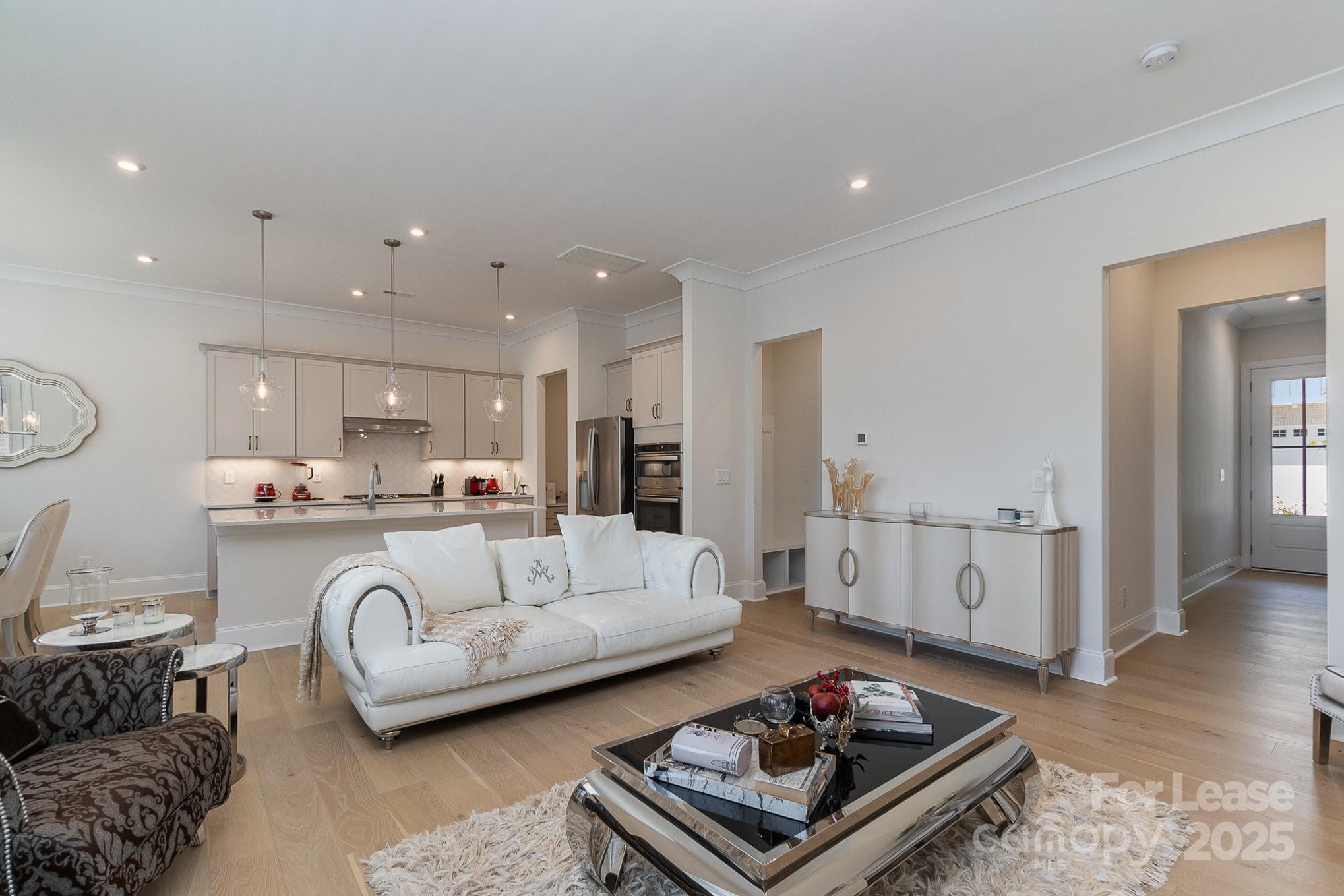 3224 Everly Enclave Way Charlotte, NC 28210 - Photo 4 of 24 a living room with furniture a rug and kitchen view