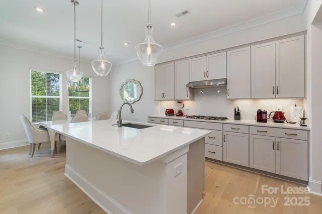 a kitchen with stainless steel appliances kitchen island granite countertop a sink and cabinets