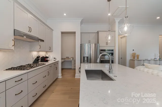 a large kitchen with a table and chairs