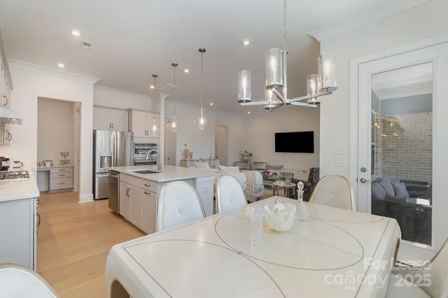 a kitchen with a wooden table and cabinets