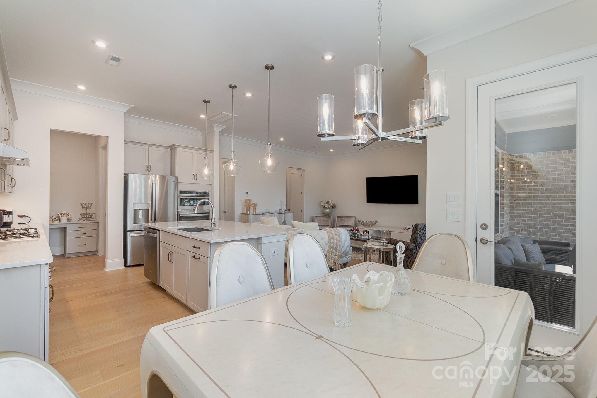 3224 Everly Enclave Way Charlotte, NC 28210 - Photo 7 of 24 a large kitchen with a table and chairs