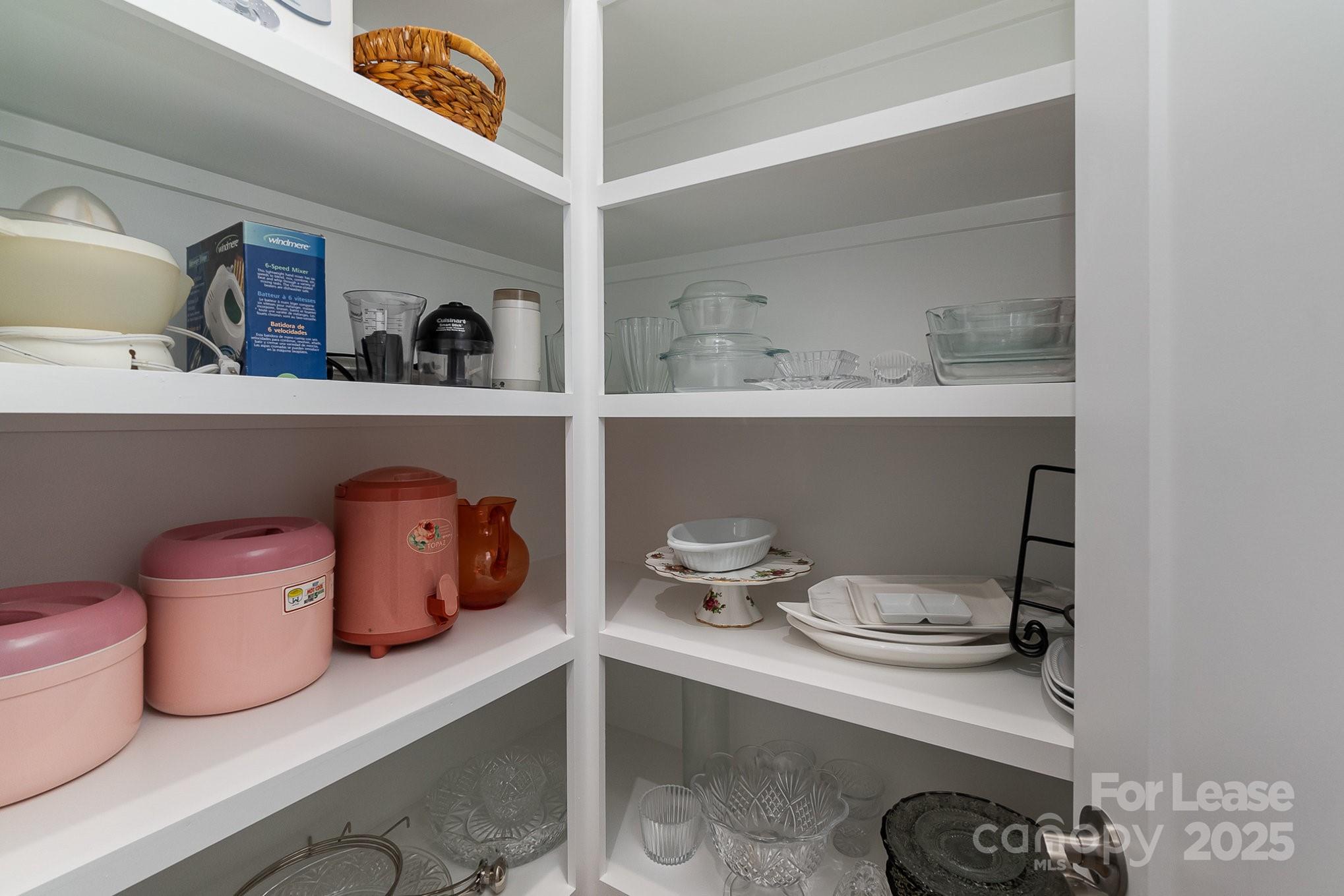 3224 Everly Enclave Way Charlotte, NC 28210 - Photo 8 of 24 a kitchen with a wooden table and cabinets