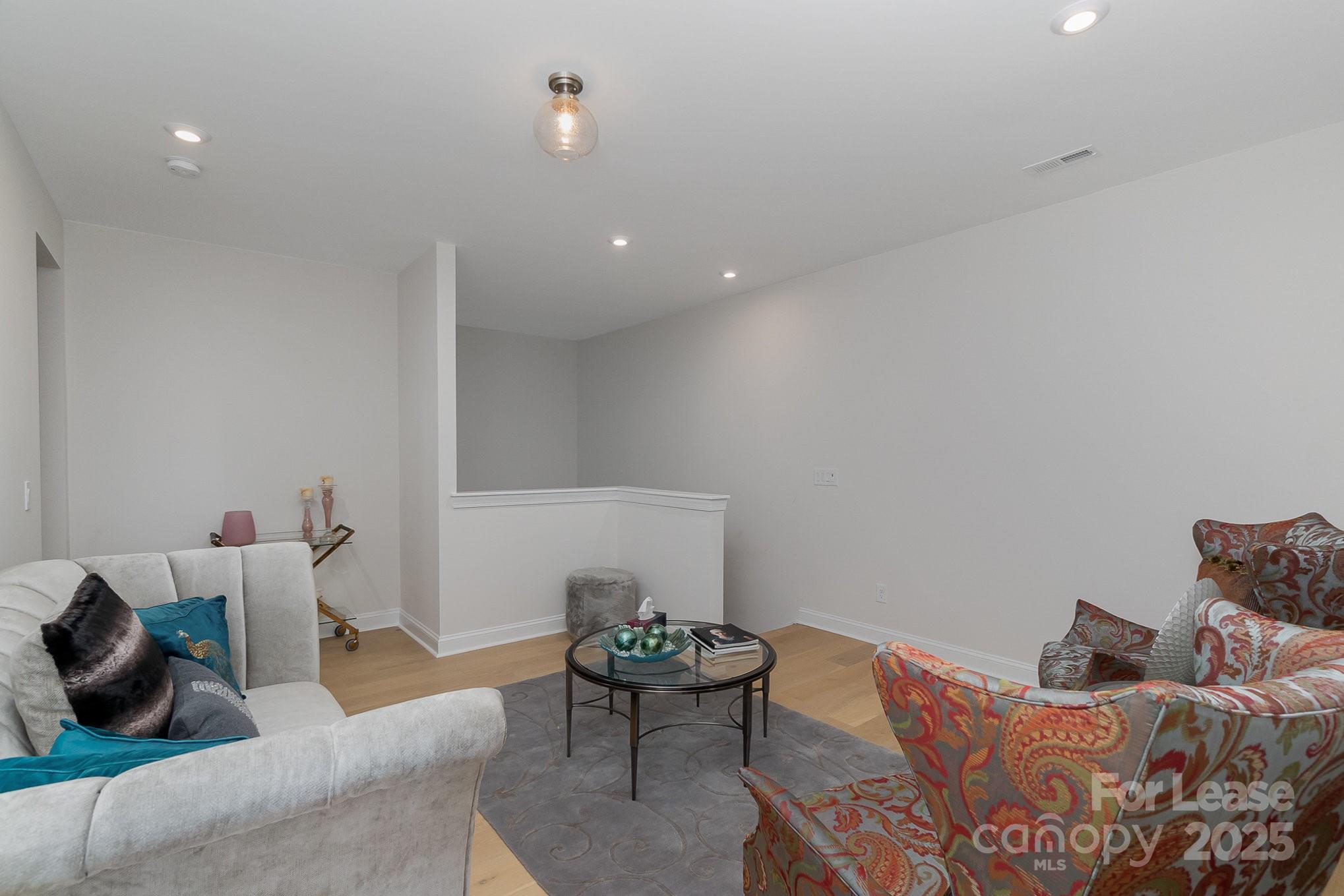 3224 Everly Enclave Way Charlotte, NC 28210 - Photo 10 of 24 a living room with furniture and a chair