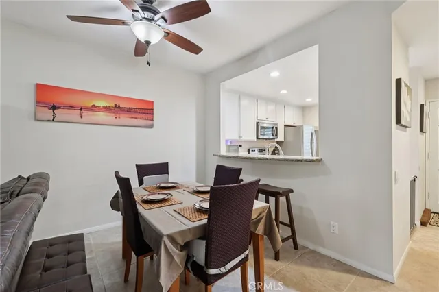a view of a dining room with furniture and a chandelier fan