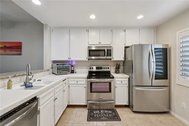 a kitchen with a sink appliances and cabinets