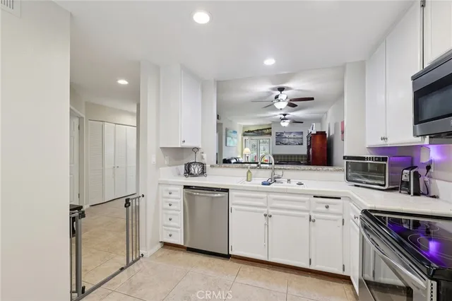 a kitchen with stainless steel appliances granite countertop a sink and cabinets