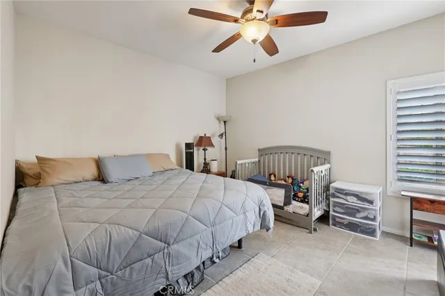 a spacious bedroom with a bed and a window