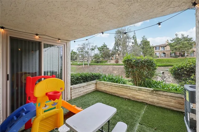 a view of a backyard with furniture and a tub