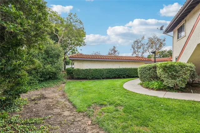 a view of a swimming pool with a patio and a yard