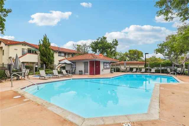a view of a swimming pool with a lawn chairs