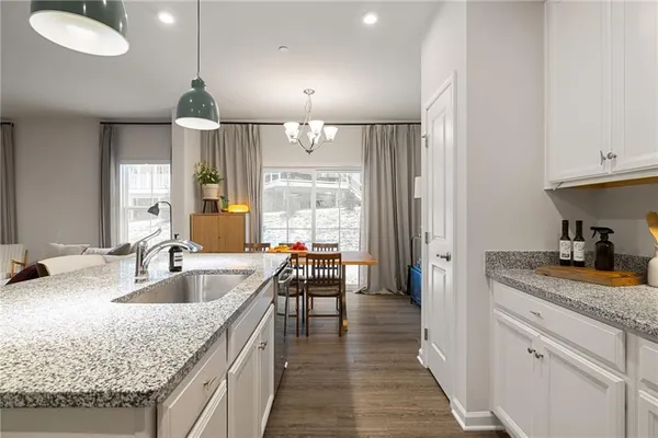 a kitchen with stainless steel appliances granite countertop a sink refrigerator and microwave