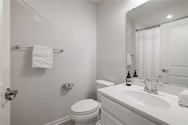 a bathroom with a sink and mirror with bathtub