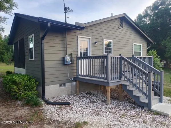 a view of a house with a yard and deck