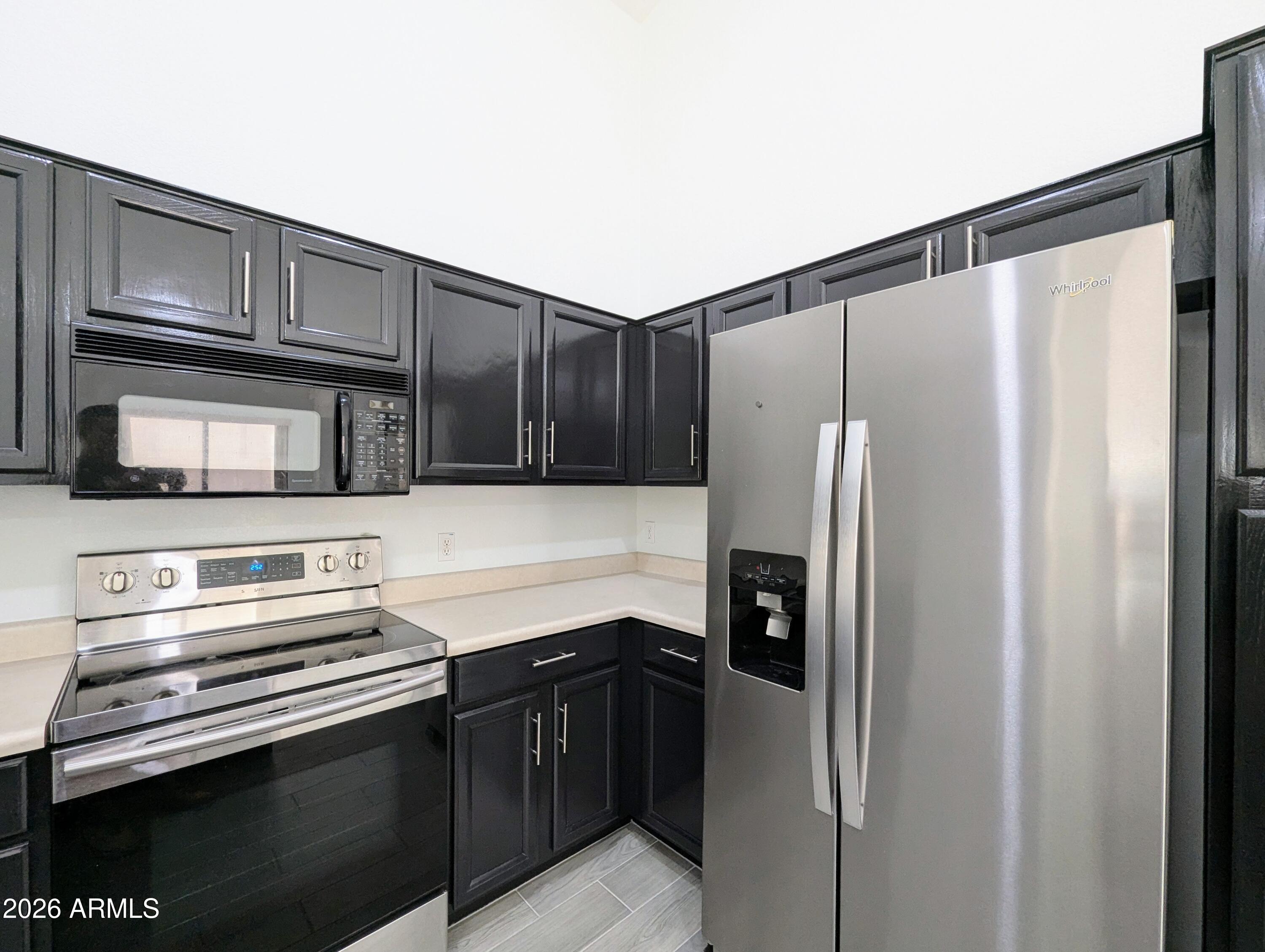 5424 West Wagoner Road Glendale, AZ 85308 - Photo 16 of 37 a kitchen with stainless steel appliances granite countertop a refrigerator and a stove top oven