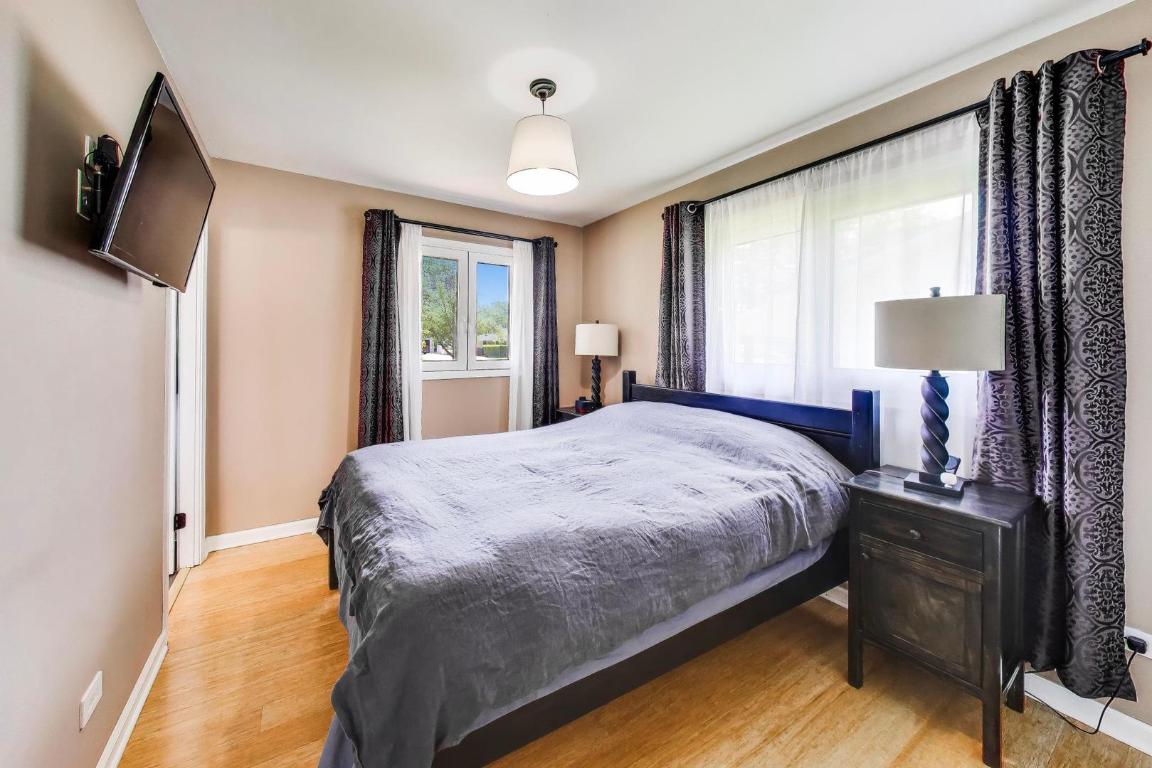 420 Bode Road Hoffman Estates, IL 60169 - Photo 9 of 20 a bed sitting in a bedroom next to a window