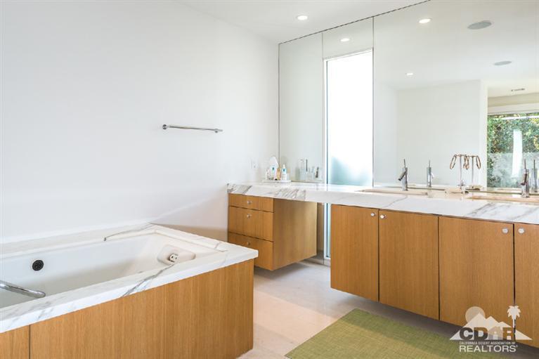 70288 Calico Road Rancho Mirage, CA 92270 - Photo 18 of 20 a bathroom with a tub sink and mirror
