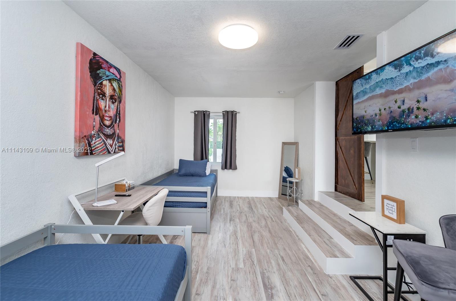 231 Northwest 44th Street Miami, FL 33127 - Photo 18 of 63 a dining room with furniture and wooden floor