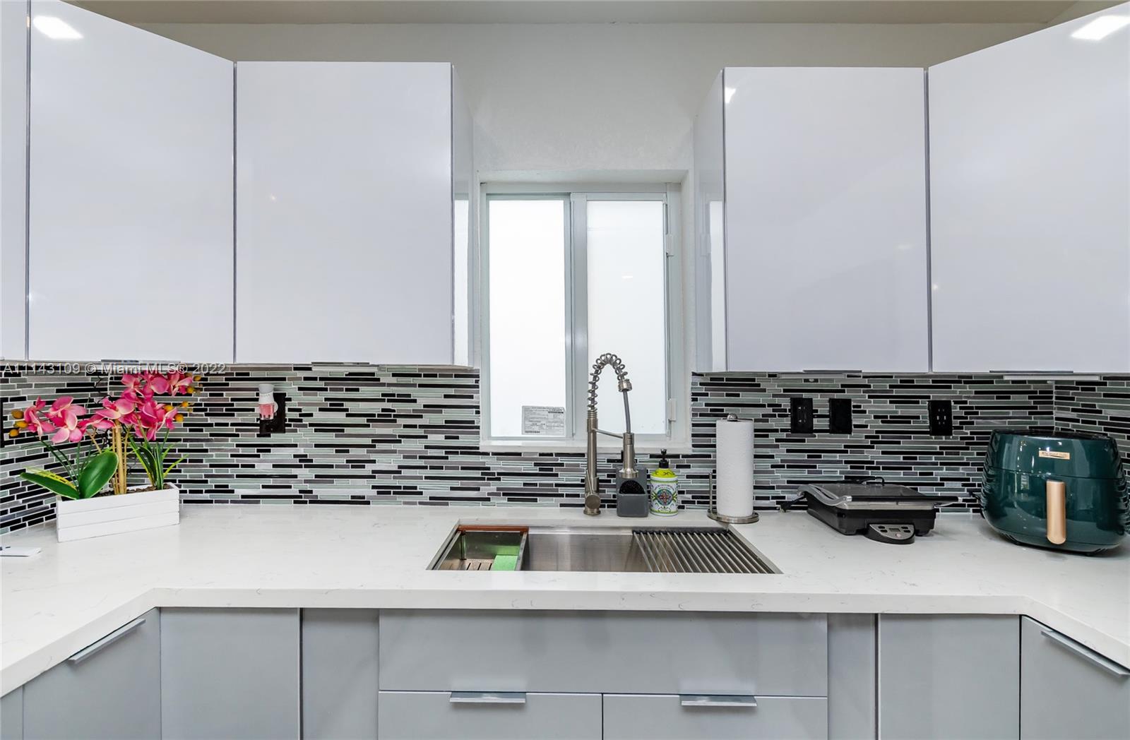 231 Northwest 44th Street Miami, FL 33127 - Photo 27 of 63 a kitchen with a sink and cabinets