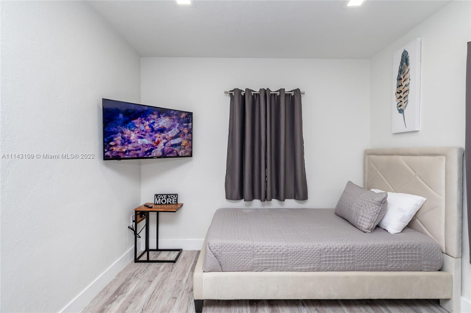 231 Northwest 44th Street Miami, FL 33127 - Photo 34 of 63 a bedroom with a bed and a wall painting