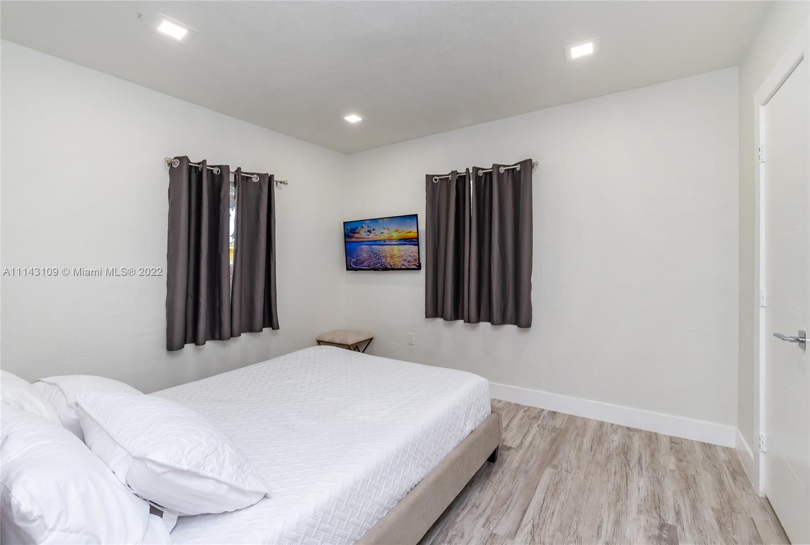 231 Northwest 44th Street Miami, FL 33127 - Photo 44 of 63 a bedroom with a bed and a flat screen tv