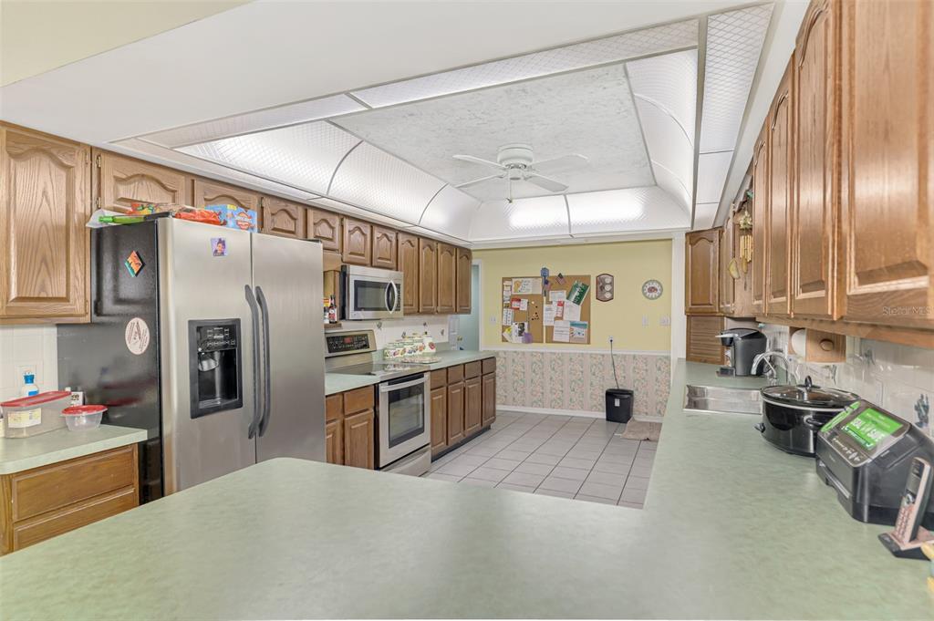 1137 Ponderosa Road Venice, FL 34293 - Photo 17 of 48 a large kitchen with stainless steel appliances granite countertop a refrigerator and a sink