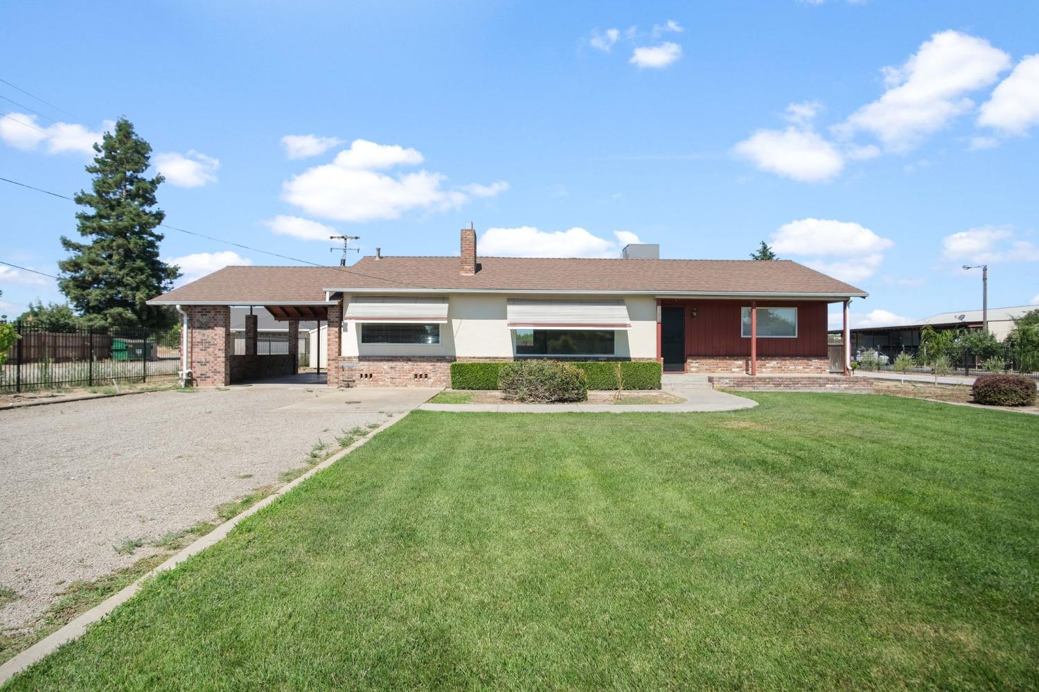 a view of a house with a yard and sitting area