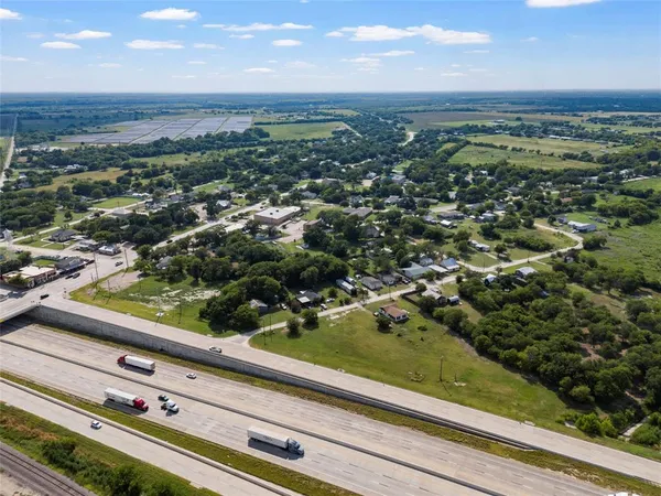 an aerial view of residential houses with yard