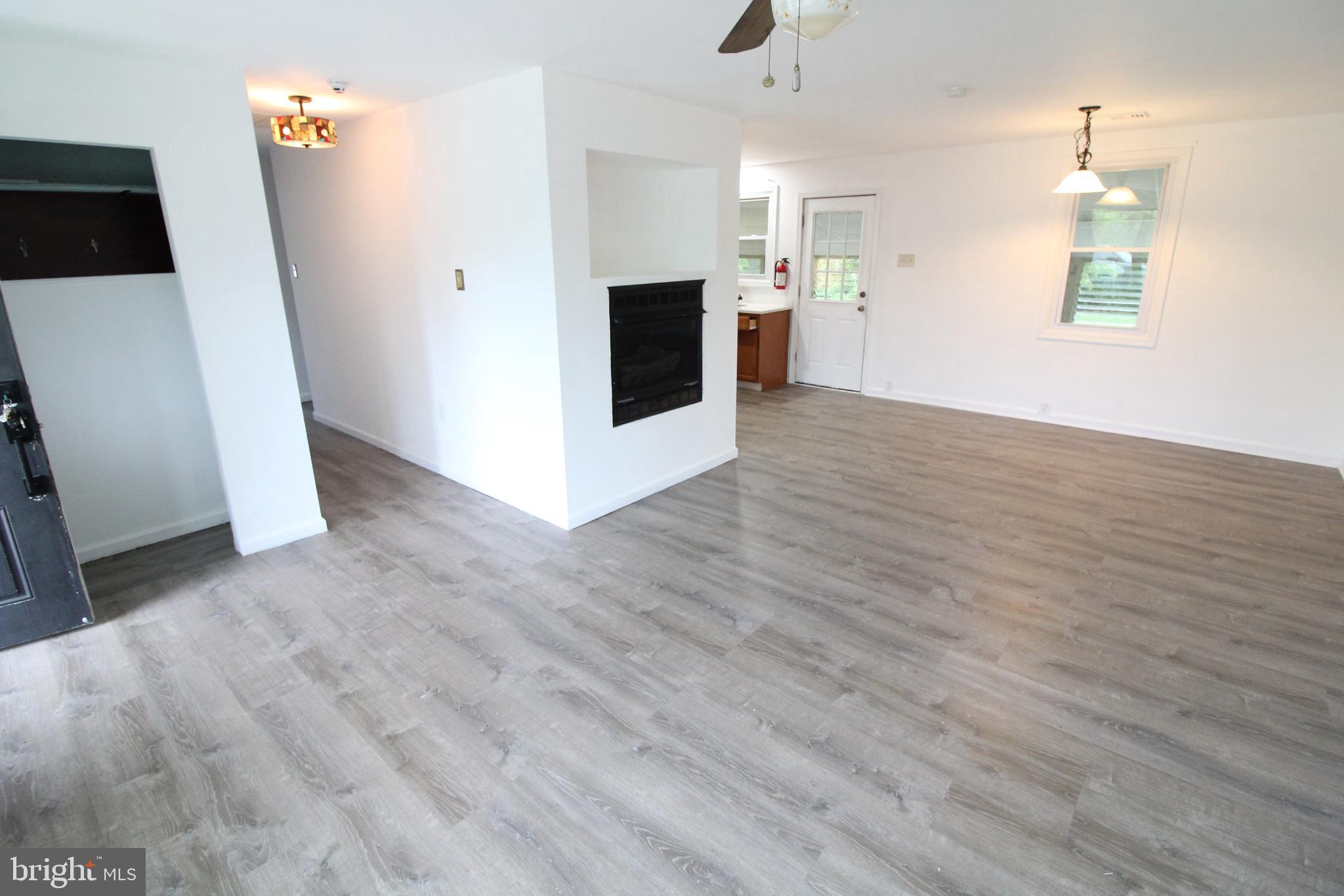 310 Piute Trail Browns Mills, NJ 08015 - Photo 11 of 23 an empty room with wooden floor and fireplace