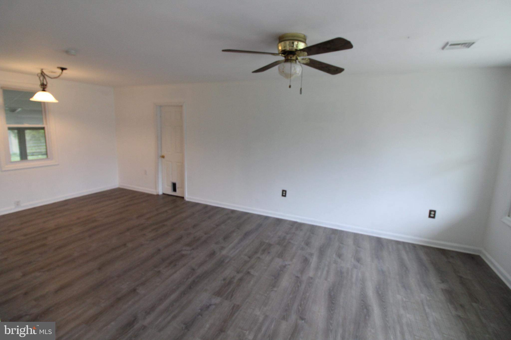 310 Piute Trail Browns Mills, NJ 08015 - Photo 10 of 23 wooden floor in an empty room with a window