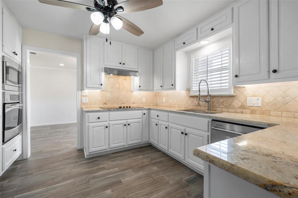 5112 Old Caufield Ranch Road McGregor, TX 76657 - Photo 15 of 38 Kitchen with light stone counters, white cabinets, ceiling fan, and appliances with stainless steel finishes