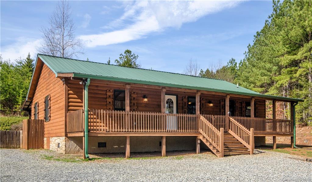 a view of a house with backyard porch and sitting area