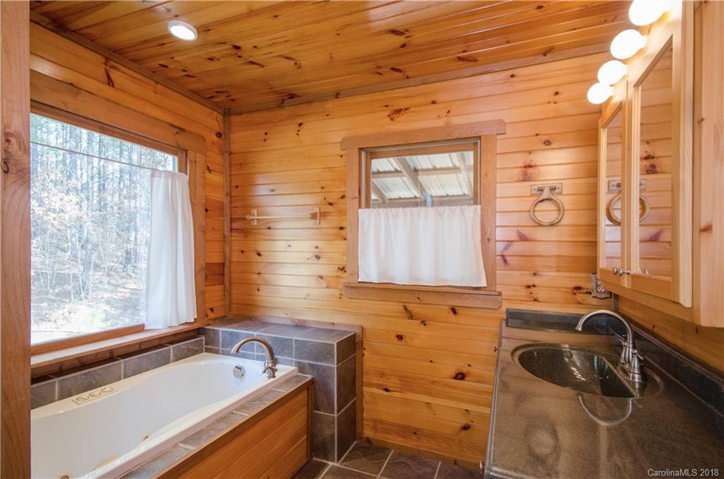 139 Stanley Ln Mill Spring, Unit 8 Mill Spring, NC 28756 - Photo 11 of 22 a bathroom with a sink and a bathtub